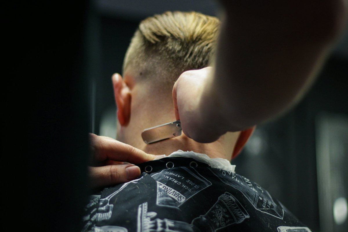 Barber finishing a short men's haircut
