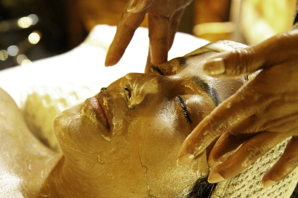 Gold facial mask being applied