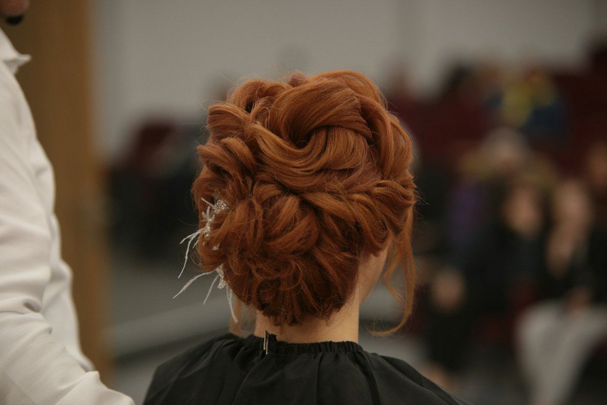 Copper-red hair styled in an up-do at the salon
